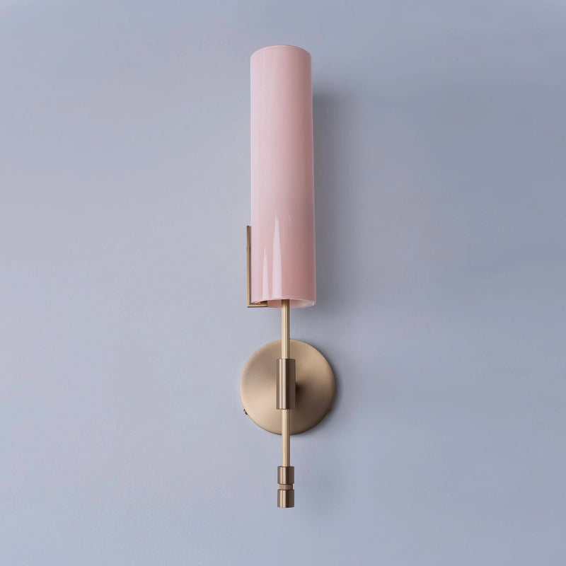 Avram Rusu sconce with pink cylindrical shade and brass wall attachment.