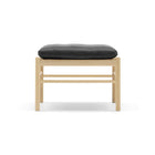 Wooden stool with a black cushion