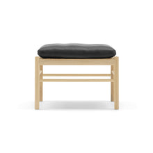 Wooden stool with a black cushion