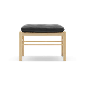 Wooden stool with a black cushion