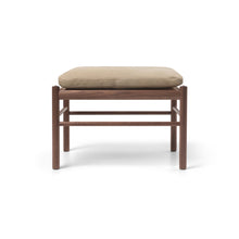 Wooden stool with beige pillow
