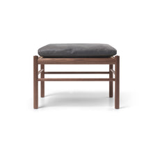 Wooden stool with a gray cushion