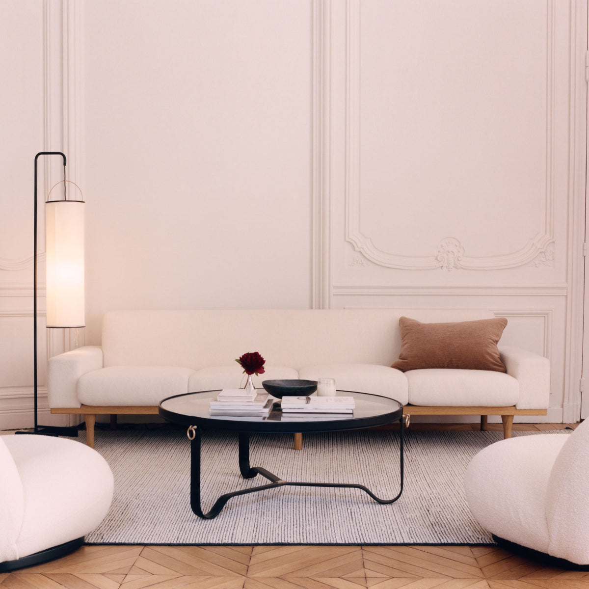 A eclectic living room featuring a white Danish Modern sofa by Illum Wikkelsø.