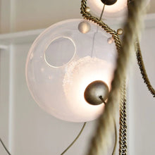 Larose Guyon Abysse 03 – Glass Sphere Chandelier with Brass Chains